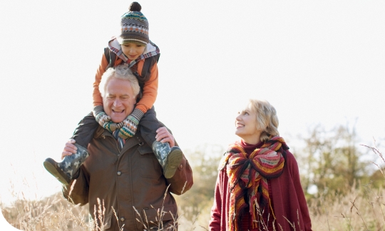 Couple making the most of their retirement by travelling to visit their grand-child